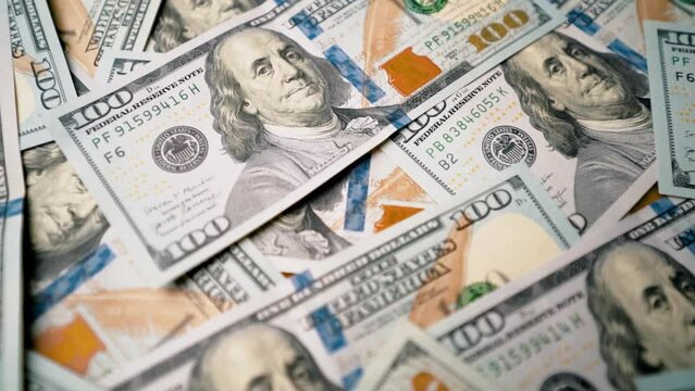 Scattered 100 dollar bills travelling close-up shot
