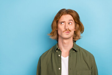 Portrait of attractive funky doubtful bewildered red-haired guy overthinking isolated over bright blue color background - obrazy, fototapety, plakaty