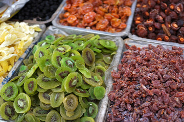 Various dried fruits selling on market stall, The most common varieties are raisins, dates, prunes, figs and apricots.