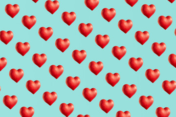 Fototapeta na wymiar Red hearts, creative love and passion inspired pattern on pastel blue background.