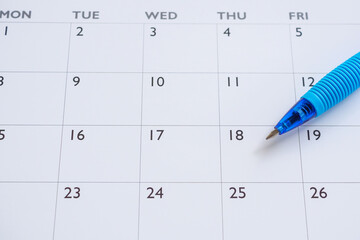 Blue pen on calendar page background business planning appointment meeting concept