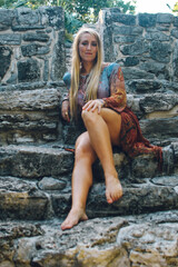 blonde girl posing in ancient ruins in mexico lifestyle concept