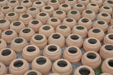 Freshly made clay pots on the ground for drying