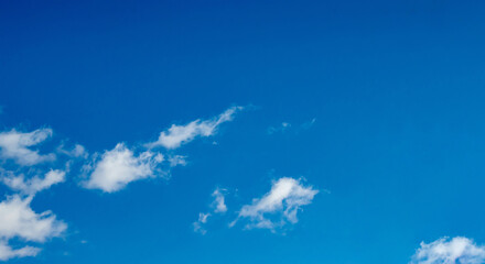 Beautiful blue sky with small white clouds, copy space.