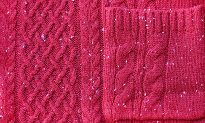 Red wool knitted sweater, abstract background, close-up, top view