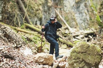 Tourist hiking on the mountain with FPV drone goggles