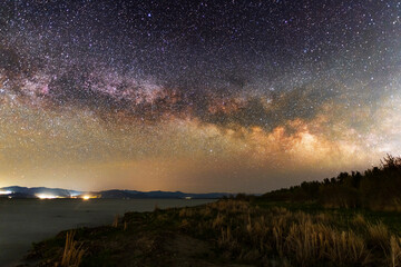 Fototapeta na wymiar Beautiful bright milky way galaxy at the night sky over lake.