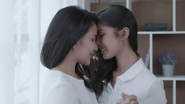 Medium short of two beautiful women lovers are hugging, kissing and taking care of each other. Romance felling. LGBTQ concept. soft mood and focus.