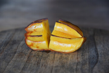Rotten star fruit,over ripe fruit,in yellow color,placed on brown wooden table