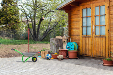 Small beautiful wooden house shed or storage hut for garden tools equipment and bicycles at...