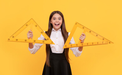 amazed teen girl in school uniform hold mathematics triangle for measuring, high school