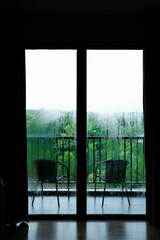 Frame of wet dark windows with raining outside.