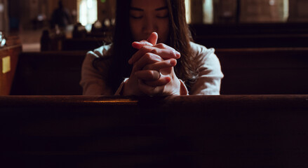 Young woman prayer's pray alone in church, People pray to God with folded hands, old wooden classic...