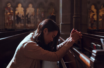 Fototapeta na wymiar Young woman prayer's pray alone in church, People pray to God with folded hands, old wooden classic long chairs background