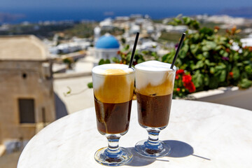 Two glasses of frappe cold coffee on Santorini island.