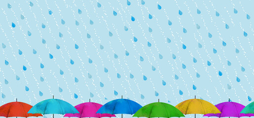 斜めに降る雨とたくさんのカラフルな傘1