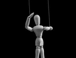 Puppet on strings. Exploit, control, abusive relationship concept. Alcohol, drug, gambling, internet addiction. Doll dependent on puppeteer. Black and white. High quality photo
