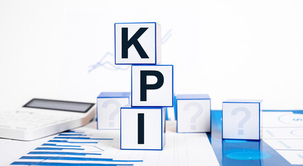 Key performance indicators. Cubes with KPI text, calculator and graphs. Business targets setting,...