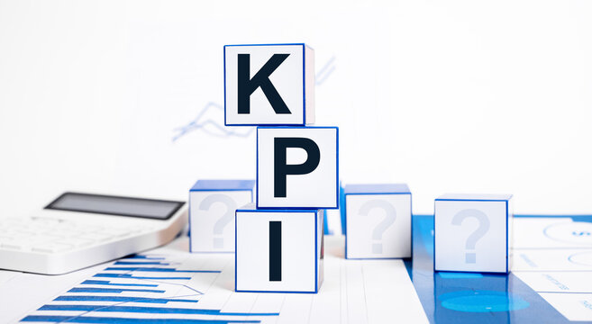 Key Performance Indicators. Cubes With KPI Text, Calculator And Graphs. Business Targets Setting, Measurement And Tracking Progress. Job Targets Evaluation. High Quality Photo