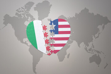 puzzle heart with the national flag of liberia and italy on a world map background. Concept.