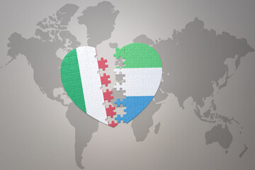 puzzle heart with the national flag of sierra leone and italy on a world map background. Concept.