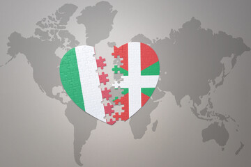 Fototapeta premium puzzle heart with the national flag of basque country and italy on a world map background. Concept.