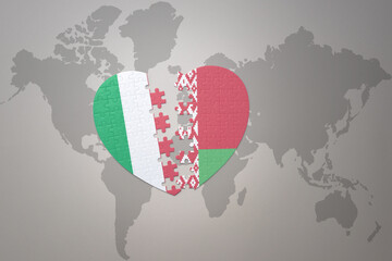 puzzle heart with the national flag of belarus and italy on a world map background. Concept.