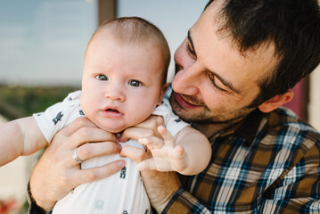 Happy father with his son playing at home. Portrait of dad with baby boy.