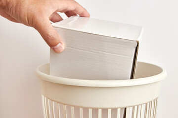 Paper packaging is discarded for disposal and recycling.