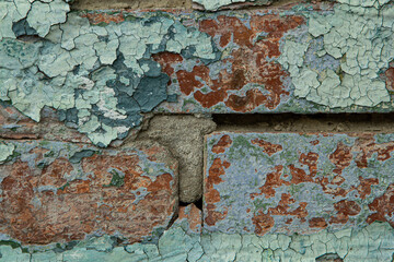 old brick wall with peeling green paint, texture, design