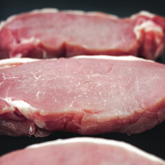 Raw veal meat fillet on dark background. Close up