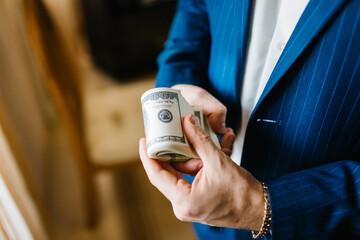 Man in suit showing dollar banknotes. Hands counting money American dollars. Income. Business...