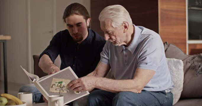 Father and son examining photos together