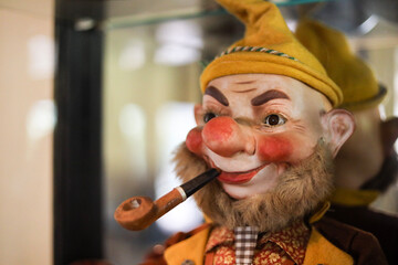 portrait of old man doll with pipe, beard and yellow felt hat wearing Austrian outfit