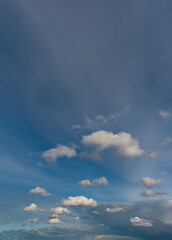 Naklejka na ściany i meble Fantastic clouds at sunrise, vertical panorama