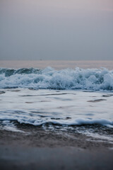 Obraz premium Bubbles on golden beach with ocean water in the morning at Thailand beaches.