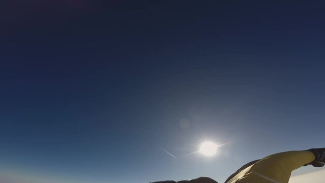 a man flies in a wingsuit suit in a clear sky in sunny weather
