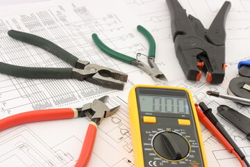 Multimeter and tools for installing an electrical control panel in close-up on an electrical...