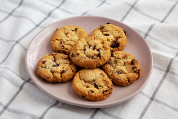 Homemade Cookies with White Chocolate and Dried Cranberries on a Plate, side view.