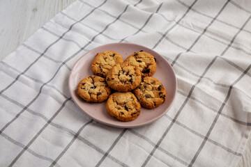 Homemade White Chocolate Cranberry Cookies on a Pink Plate, side view.
