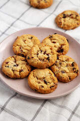 Homemade White Chocolate Cranberry Cookies on a Pink Plate, low angle view. Close-up.