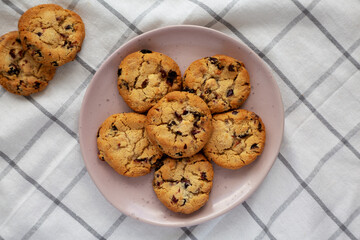 Homemade White Chocolate Cranberry Cookies on a Pink Plate, top view. Flat lay, overhead, from above.