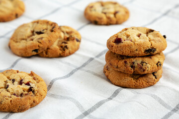 Homemade White Chocolate Cranberry Cookies on a Pink Plate, side view.