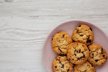 Homemade White Chocolate Cranberry Cookies on a Pink Plate, top view. Flat lay, overhead, from above. Space for text.