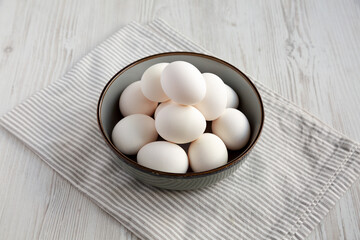 Raw Cage Free White Eggs in a Bowl, side view.