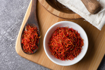 A mound of red saffron.
Dry saffron spice on  background. Dry saffron flower.