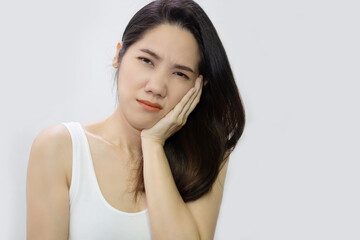 Asian beautiful woman touch her cheek with feel toothache and painful and have hyper sensitive...