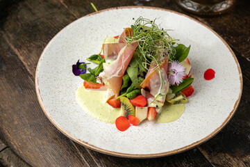 Salad with strawberries, parmesan and prosciutto. 