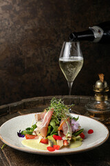 Salad with strawberries, parmesan and prosciutto. 