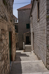 Sibenik, Croatia - May 26, 2022 - narrow old street and yard in Sibenik city, medieval zone